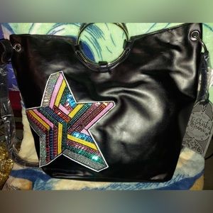 Tshirts and jeans black hand bag with a beautiful star design in the front